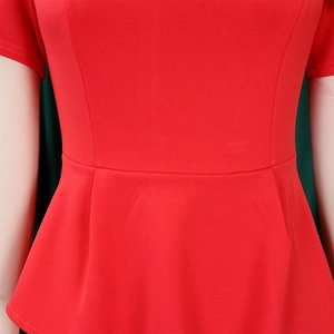 Detail of red high-waisted pencil dress with peplum hem and princess seam structure