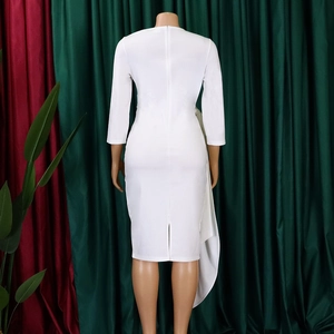 Detail of white slim-fit dress featuring side drape, back zipper, and hem slit design