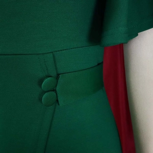 Detailed view of dark green dress waist with ribbed fabric and matching cloth buttons