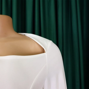 Close-up of white square neck dress featuring unique hollow-out shoulder design