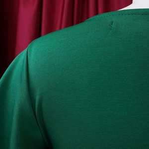 Detailed view of the shoulder seam and green fabric texture on a women pencil dress