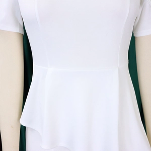 Close-up of white dress showing waist peplum detail and textured fabric stitching