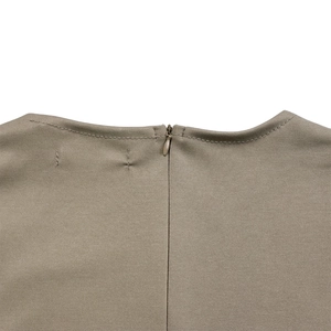 Close-up of olive green knitted dress neckline featuring a discreet invisible back zipper