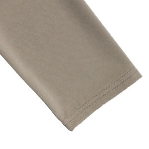 Macro detail of taupe knit fabric texture and high-quality double-line stitching finish