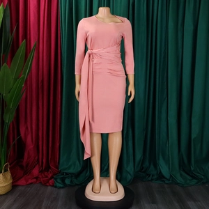 Pink sheath dress detail with asymmetric cutout neckline and draped pleated waist ties