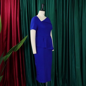 Detail of royal blue peplum dress showing asymmetric neckline and fitted waist design