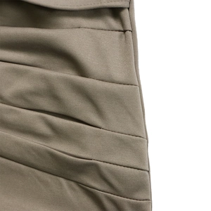 Macro detail of elastic ruched knit fabric texture and neat stitching in khaki brown dress