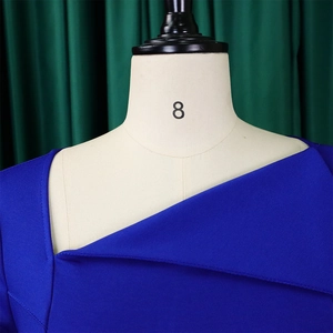 Close-up of asymmetrical slanted neckline on royal blue elegant dress on mannequin
