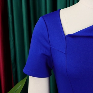 Detail of royal blue dress showing asymmetric square neck and horizontal knit texture