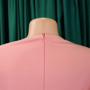 Close-up of pink dress back featuring a neat invisible zipper and fine fabric texture