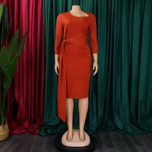 Detail view of orange slim-fit dress with waist tie and hollowed collar cutout