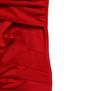 Close-up of red ruched fabric detail showing refined pleated texture and quality stitching