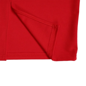 Close-up of split hem detail on solid red dress with neat stitching and quality seam finish