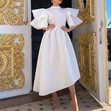 Detailed view of the dramatic double-layered ruffle sleeves on this white evening dress