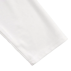 Detailed close-up of double-stitched cuffs on white soft cotton long-sleeved dress