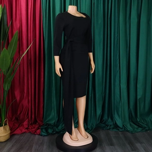Detail of a black bodycon dress featuring elegant waist ties and soft knitted texture