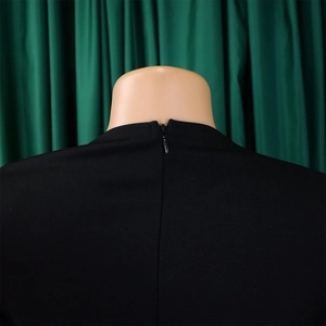 Detail of invisible back zipper closure on elegant black office dress with woven fabric