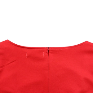 Detail of red dress with a seamless invisible back zipper and reinforced collar stitching