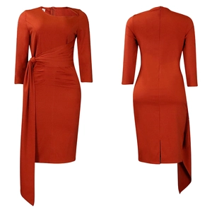 Detail of burnt orange ruched midi dress with asymmetric draping and side tie design