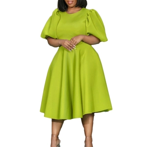 Detail of high waist lime green A-line dress with elegant puff sleeves and flared hem