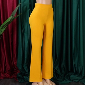 Front view of high waisted wide leg trousers in vibrant yellow on a mannequin display