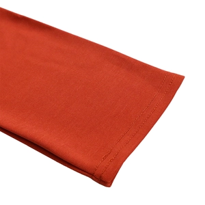 Detailed macro shot of the red professional dress hem with precise double-needle stitching