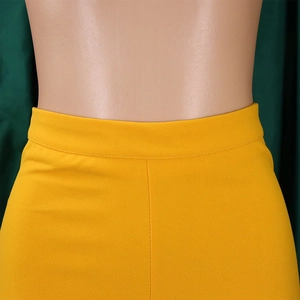 Detail of high-waisted ginger wide leg trousers featuring precise stitching and woven fabric