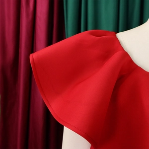 Détail des manches à volants rouges élégantes et texture du tissu de la robe de soirée