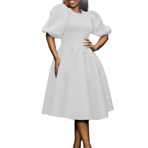 Detail of elegant white A-line dress with puff sleeves and cinched waist design