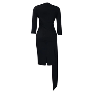 Detail of invisible rear zipper and asymmetric hemline on this black long sleeve dress