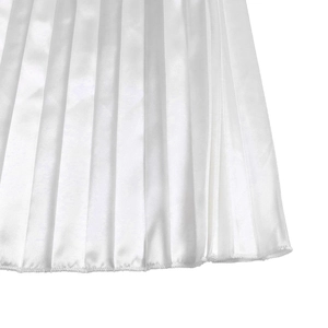 Detailed close-up of white pleated fabric showing satin texture and fine hemline finish