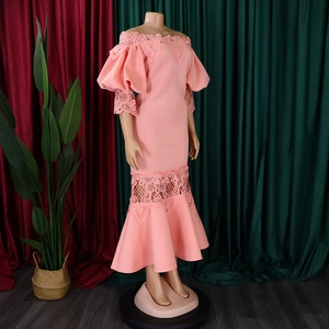Detail of coral pink off-shoulder dress with lace embroidery and ruffled sleeves