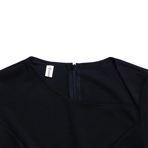 Detail of the asymmetric neckline and hidden back zipper on this black OL dress