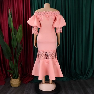 Detail of peach off-shoulder mermaid dress with delicate lace floral hem and puff sleeves