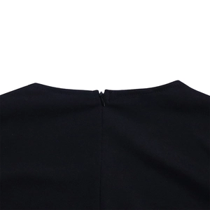 Detail view of the seamless invisible back zipper on a textured black office dress