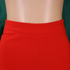 Detailed close-up of high-waisted wide-leg red pants showing fabric texture and waistband