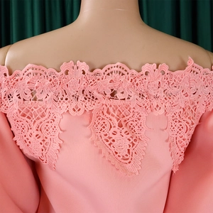 Close-up of pink off-shoulder dress featuring exquisite lace embroidery and scallop trim
