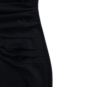 Detail of black office dress featuring ruching and ruched fabric texture for women
