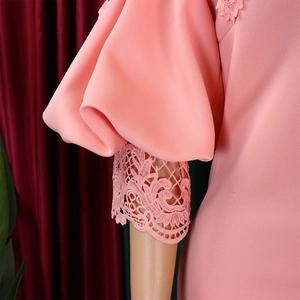 Detailed close-up of pink puff sleeves with exquisite floral lace trim on cuff