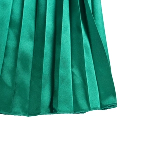 Close-up of bright green pleated satin fabric showing detailed texture and silky drape