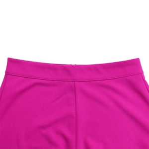 Detailed view of magenta high-waisted trousers featuring a seamless waist and hidden zipper