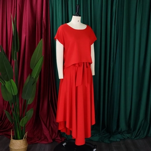 Detail of red two-piece set featuring short sleeve top and high-waist maxi skirt