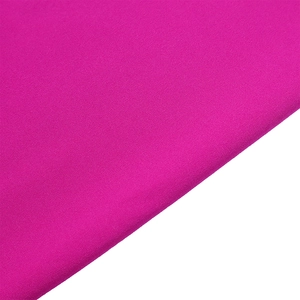 Detailed macro view of the fuchsia fabric texture and weave for wide leg trousers