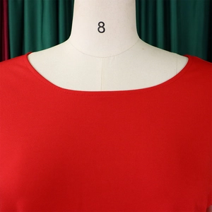 Close-up of the round neckline and fine knit texture on this elegant red plus size top