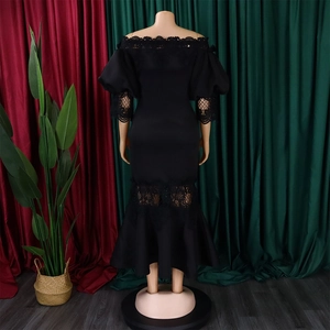 Detailed view of the elegant black off-shoulder fishtail dress with floral lace trim