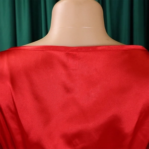 Close-up of red satin V-neck dress with glossy silk texture on a mannequin