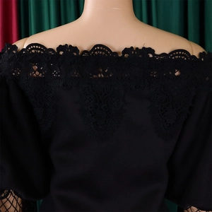 Close-up of elegant black lace off-the-shoulder neckline with intricate floral embroidery