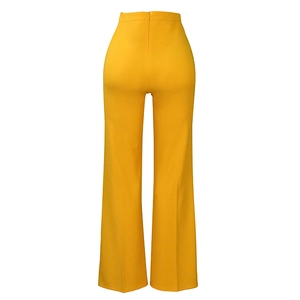 Detailed back view of bright yellow high waisted flare pants with elastic fabric texture