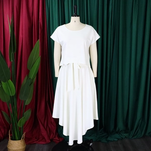 White two-piece set featuring short sleeve crop top and high-low hem skirt with bow belt