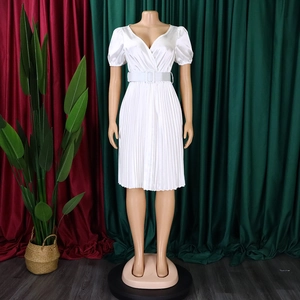 Detail of white V-neck pleated dress featuring satin luster and square buckle belt